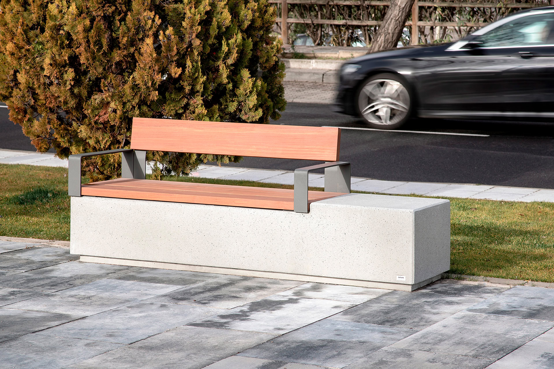 Boulevard with street furniture with armrests and wooden backrest