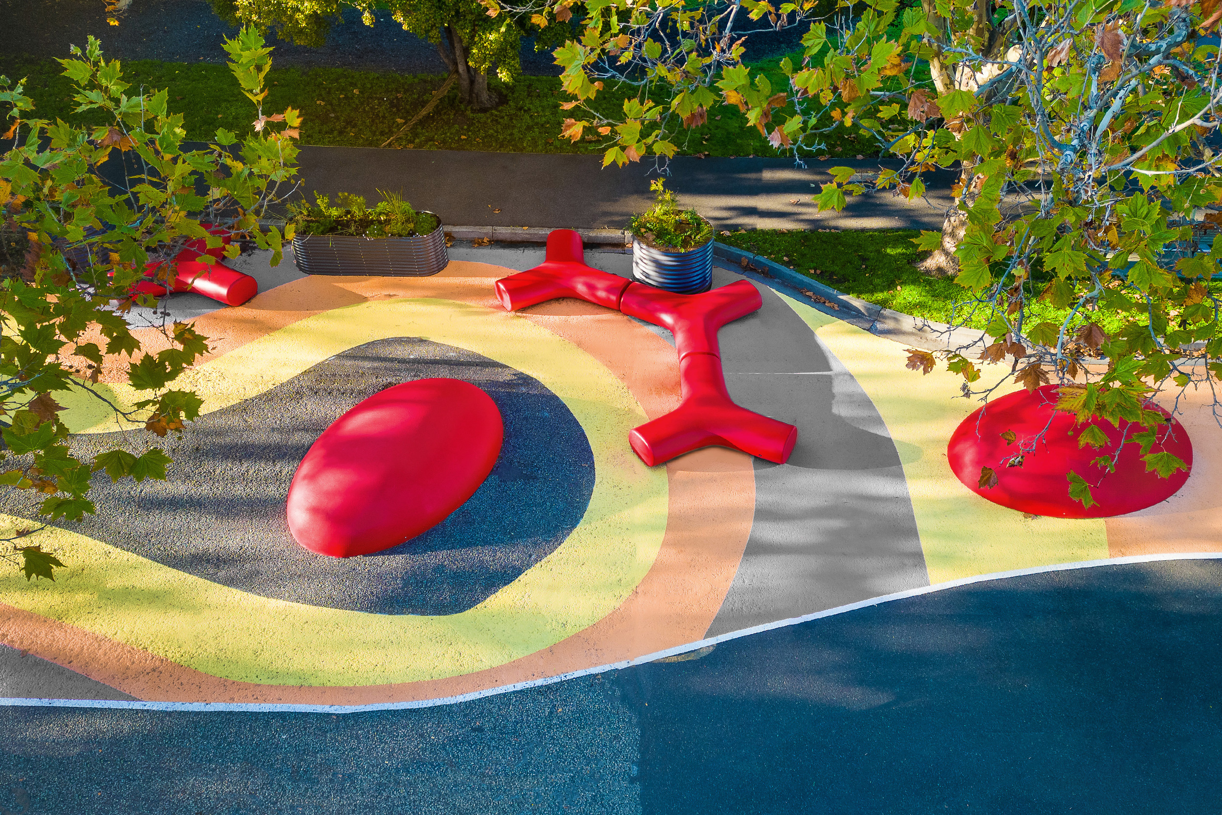 Collection of outdoor furniture from Durbanis, installed in a school environment, with a recreational area and sports area