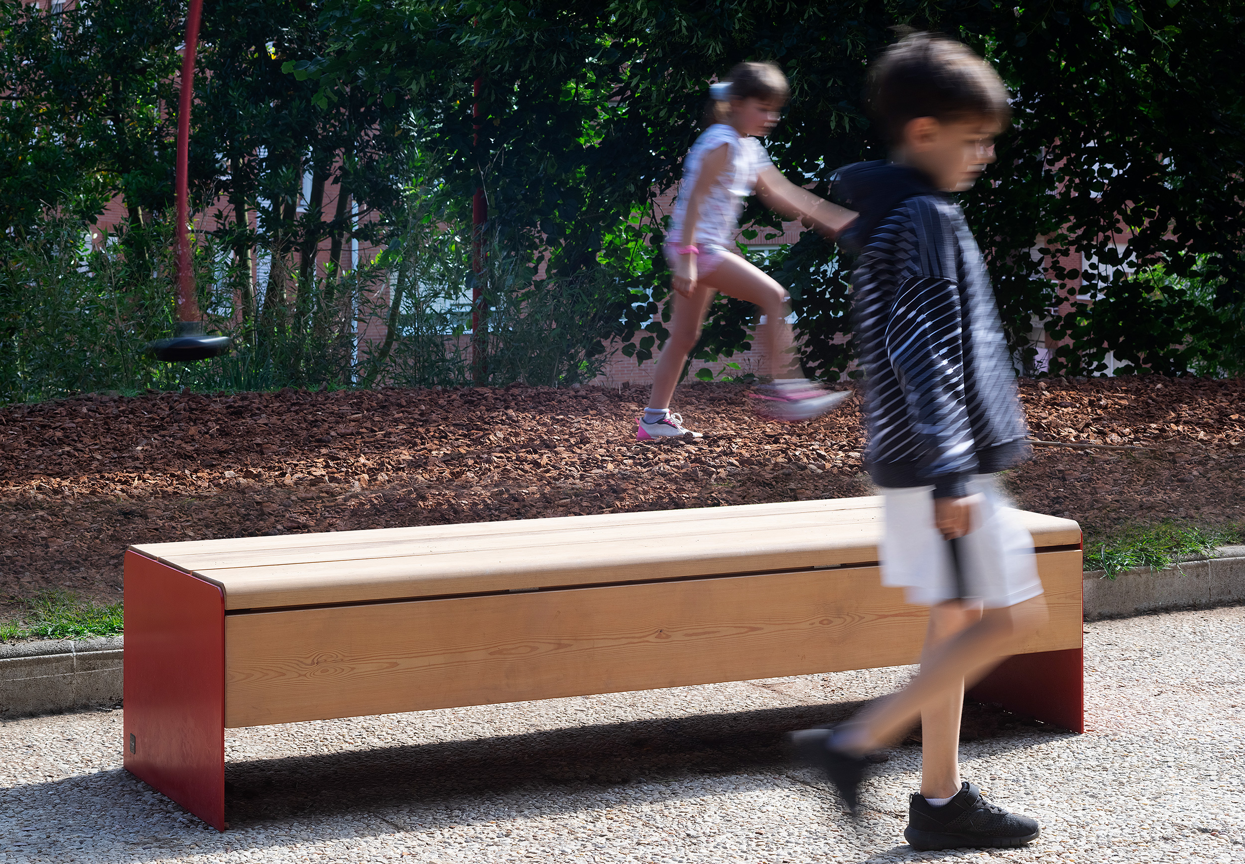 Children playing in a park with ropes and zip lines, designed by themselves