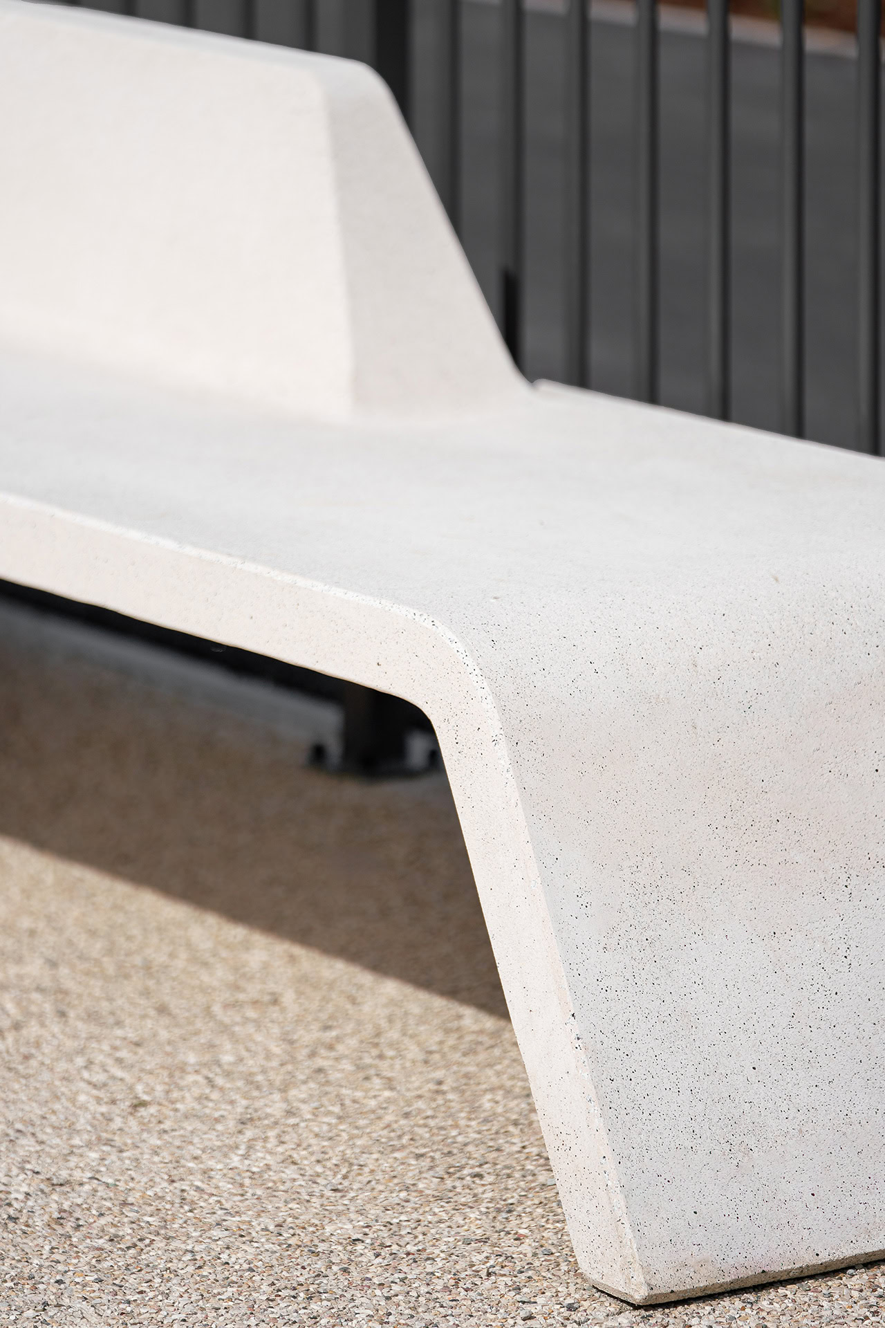 Urban bench with reinforced concrete backrest designed by Yonoh Studio